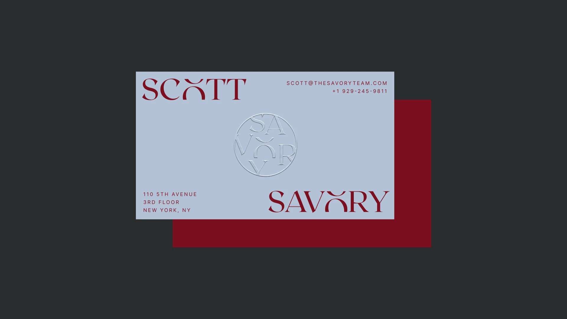 Baby blue business card for Scott Savory with wax red capitals and an embossed SAVORY seal, over a wax red card back