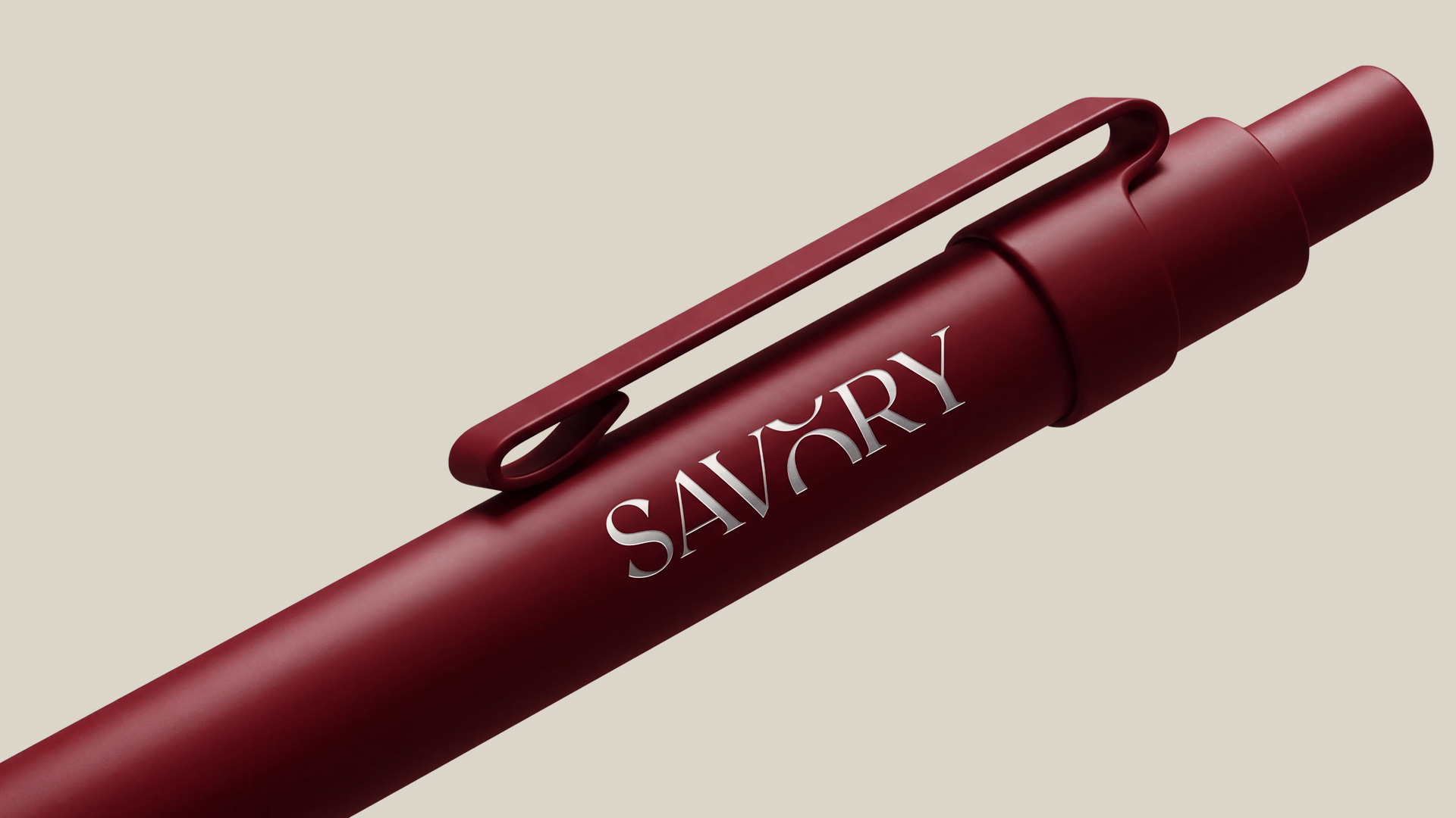 Wax red pen with a warm off-white SAVORY wordmark and metallic shading on a cream background