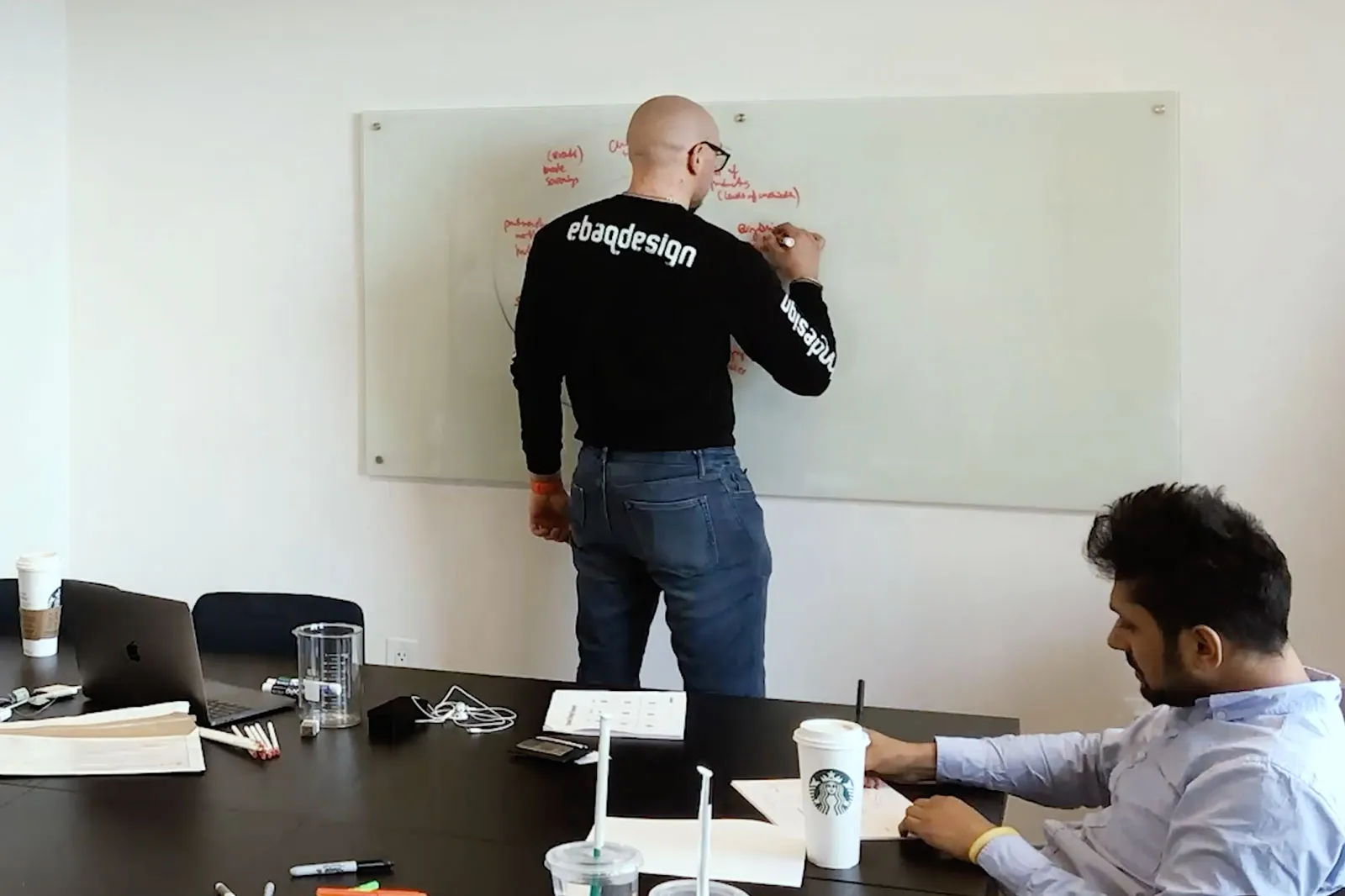 Arek running a brand strategy workshop with worksheets on the wall