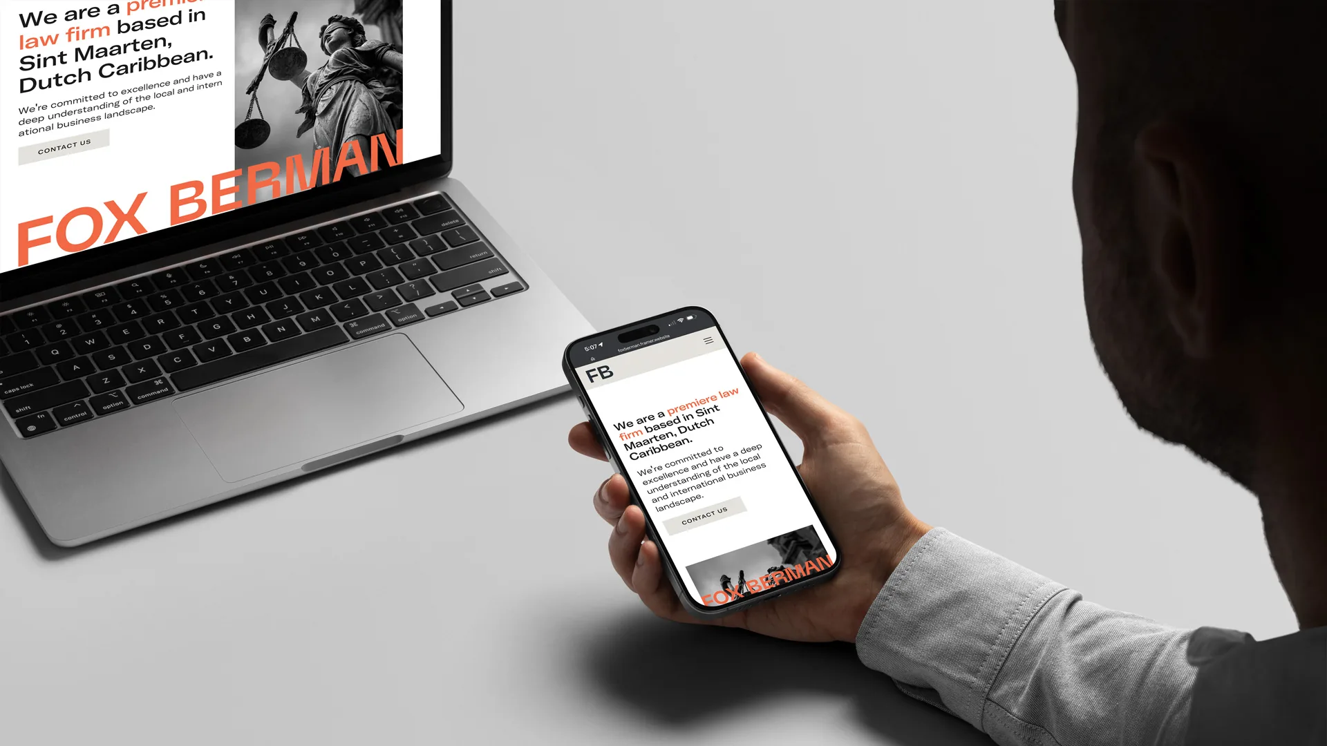 Fox Berman website on a laptop and a phone